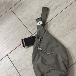 Baggallini gray mini Sling Belt Bag. Many zippers ..
Water repellent